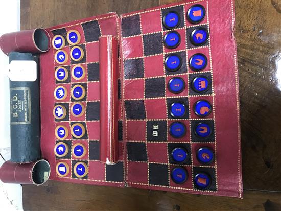 A 19th century Jaques Patent portable B.C.D. backgammon, chess and draughts board set, the gilt tooled red morocco cylinder holder